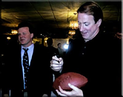 Bill Hanes and Jim Kelly Signing Football