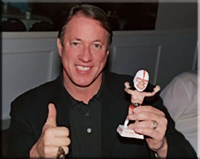 Jim Kelly Holding The Figurine