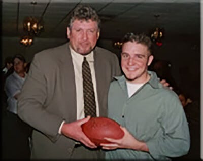 Kent Hull with the Guest Holding the Football