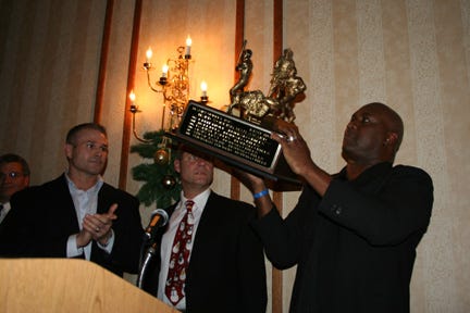 Thurman Thomas Raising the Award