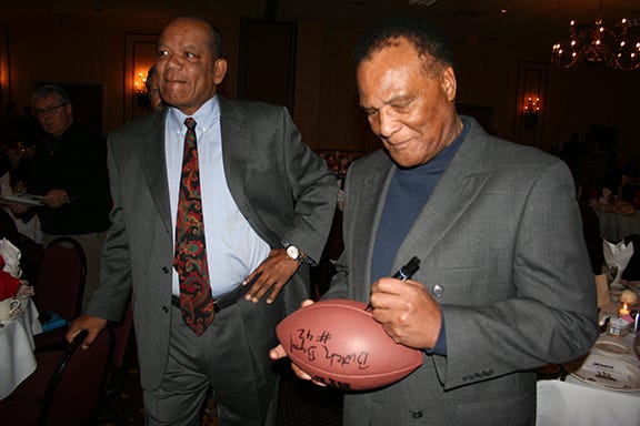 George Butch, Booker Edgerson Signing a Football