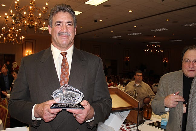 Fred Smerlas Holding the Award