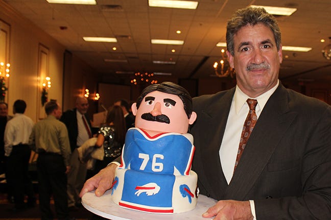 Fred Smerlas Holding a Cake