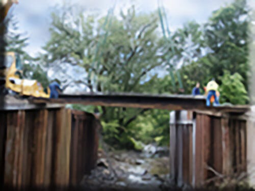 Three Workers Fixing the Bridge