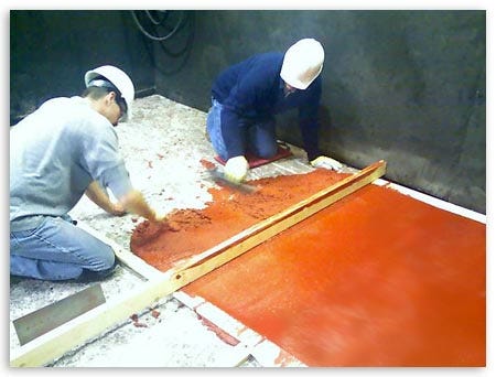 Workers Scrapping Red Paint Front View